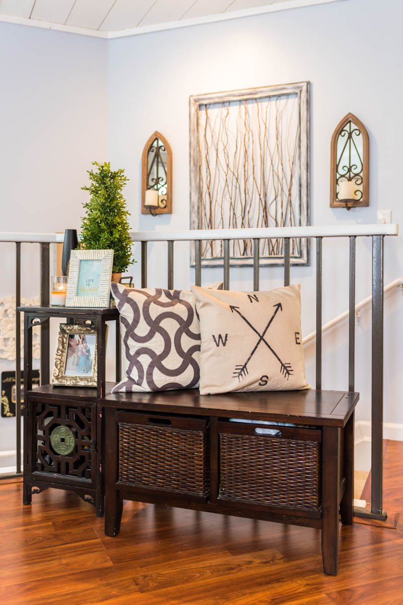 dark wood bench with light decor in entrance of las palmas condo st augustine
