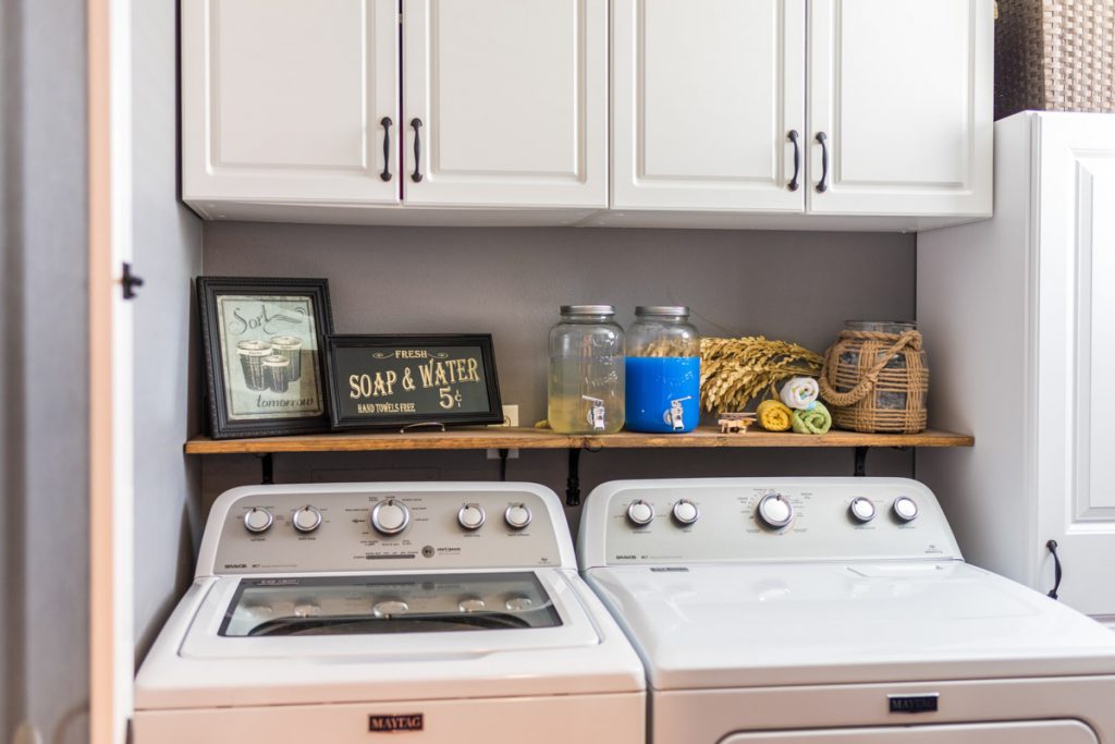 laundry room setup with open shelving and mason jar containers in las palmas condo st augustine