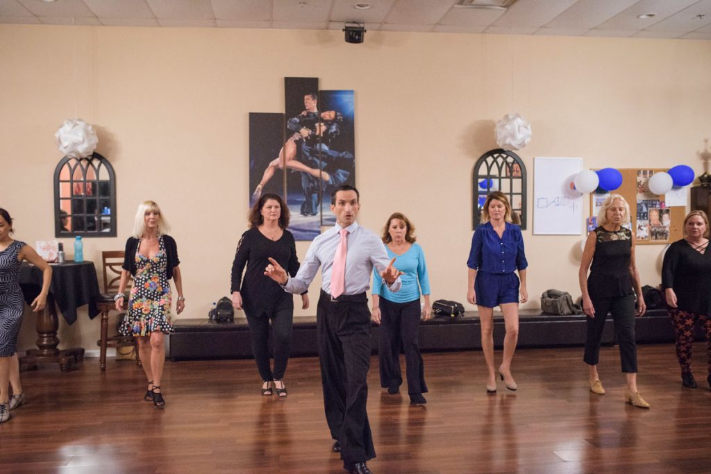 vitalie teaches a group lesson at arthur murray dance studio