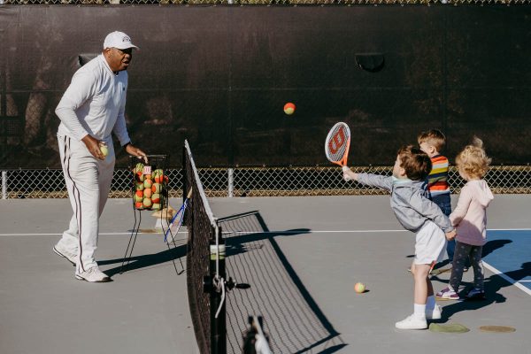 st augustine tennis instructor harold hardy plays tennis with some young students