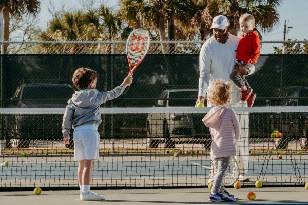 st augustine tennis instructor harold hardy plays tennis with some young students