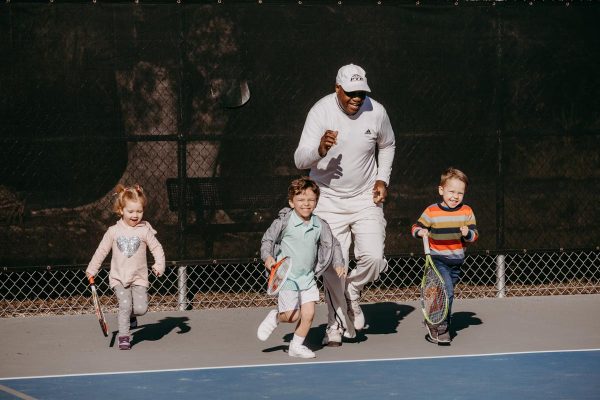tennis instructor harold hardy with his young students