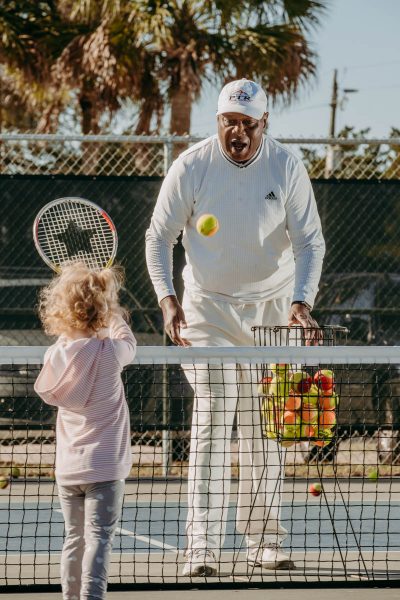 tennis instructor harold hardy with his young students