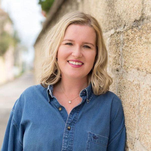 author aimee p miller leans against a coquina wall in st augustine